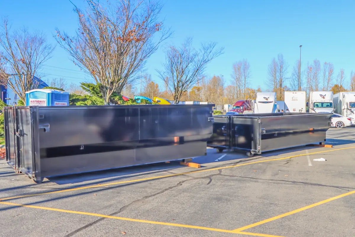 Professional dumpster rental service with roll-off container on residential driveway in Colts Neck